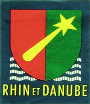 Rouge et vert, couleurs de Colmar, la massue et les flots représentant le Rhin, le Danube et la mer Méditerranée. Avec l'autorisation du site Rhin et Danube consulté le 19/1/2016
